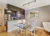 Thumbnail 5 of 23 - a kitchen and dining room with a glass table and chairs