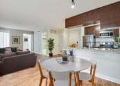 Thumbnail 23 of 23 - a living room and kitchen with a white table and chairs