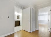 Thumbnail 11 of 23 - a bedroom with a door to a bathroom and a closet