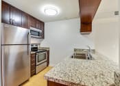 Thumbnail 18 of 23 - a kitchen with stainless steel appliances and granite counter tops
