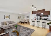 Thumbnail 1 of 23 - a living room with a couch and a table with stools