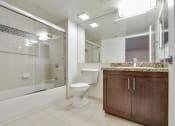 Thumbnail 3 of 23 - a bathroom with a toilet and a shower and a sink