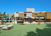 Thumbnail 20 of 53 - A modern building with a pool in front.