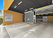 Thumbnail 51 of 53 - A parking garage for apartments with a sign that says Apartments Leasing Office Parking.