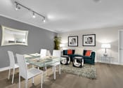 Thumbnail 33 of 53 - A modern dining room with a glass table and white chairs.