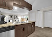 Thumbnail 31 of 53 - A kitchen with brown cabinets and a black stove top oven.