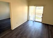 Thumbnail 5 of 22 - Sorrento Villas living room with wooden floors and a sliding glass door.