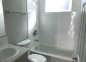 Thumbnail 5 of 12 - Millennium Apartments bathroom with sink, shower, and toilet