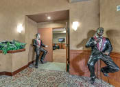 Thumbnail 17 of 46 - a statue of a man in a suit and tie in a lobby