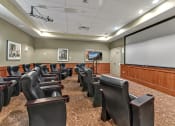 Thumbnail 18 of 46 - a large conference room with leather chairs and a projector screen