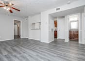Thumbnail 28 of 58 - A spacious room with a ceiling fan and lighting fixture.