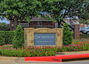 Thumbnail 1 of 15 - Oak Tree Village Apartments Exterior Front of Building and Sign
