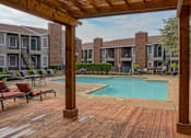 Thumbnail 7 of 15 - Oak Tree Village Apartments Pool and Lounge Chairs