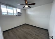 Thumbnail 9 of 27 - an empty room with a ceiling fan and a window
