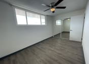 Thumbnail 8 of 27 - an empty room with a ceiling fan and a window