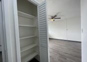 Thumbnail 10 of 27 - an empty closet in an empty room with a ceiling fan