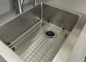 Thumbnail 12 of 27 - a stainless steel sink in a kitchen with a chrome faucet