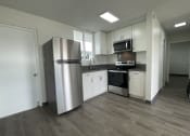 Thumbnail 17 of 27 - a kitchen with white cabinets and a stainless steel refrigerator