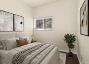 Thumbnail 7 of 13 - A bedroom with a large bed and a small tree on the side table.