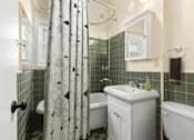 Thumbnail 10 of 13 - A white bathroom with a white tub and sink.
