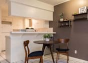 Thumbnail 3 of 9 - A kitchen with a table and chairs.