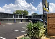 Thumbnail 7 of 9 - A parking lot with a sign that says Apartment on it.