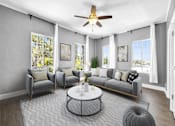 Thumbnail 1 of 13 - A living room with a grey couch, a coffee table, and a ceiling fan.
