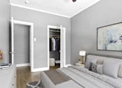 Thumbnail 4 of 13 - A bedroom with a bed, a nightstand, a dresser, and a painting on the wall.