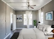 Thumbnail 7 of 13 - A bedroom with a bed, a ceiling fan, and a painting on the wall.