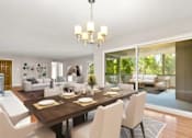 Thumbnail 24 of 27 - A dining room with a table set for six.