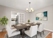 Thumbnail 17 of 27 - A dining room with a table set for four.