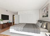 Thumbnail 26 of 27 - A bedroom with a large bed and a flat screen TV.