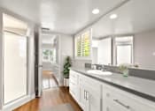 Thumbnail 20 of 27 - A bathroom with a white sink and a mirror above it.