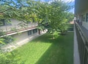 Thumbnail 6 of 7 - a view of a yard from a balcony