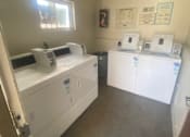 Thumbnail 7 of 7 - a laundry room with three washing machines and dryers