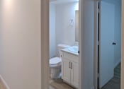 Thumbnail 10 of 22 - Punahou Circle bathroom with a toilet, sink, and cabinet.