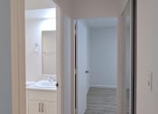 Thumbnail 9 of 22 - Punahou Circle bathroom with a sink, mirror, and wooden floors.