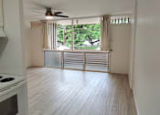Thumbnail 3 of 22 - Punahou Circle kitchen with a stove top oven and a fan on the ceiling.