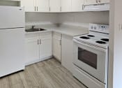 Thumbnail 2 of 22 - Punahou Circle kitchen with a stove and sink.