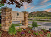 Thumbnail 3 of 17 - Reserve at Castle Highlands sign with a mountain in the background.