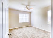 Thumbnail 19 of 20 - A room with a ceiling fan and a window.