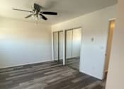 Thumbnail 7 of 16 - Seaview bedroom with a ceiling fan and a closet with sliding mirrored doors.