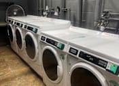 Thumbnail 15 of 16 - Seaview laundry room with a row of washing machines .
