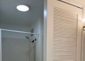 Thumbnail 7 of 13 - A white bathroom with a toilet, sink, and shower.