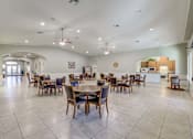Thumbnail 18 of 19 - A spacious dining room with a large table and chairs.
