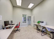 Thumbnail 19 of 19 - A room with a white desk and a red chair.