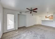 Thumbnail 2 of 19 - A room with a ceiling fan and carpeted floor.