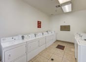 Thumbnail 10 of 19 - A row of sinks in a public restroom.
