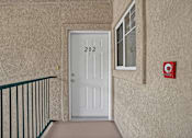 Thumbnail 13 of 48 - A white door with the number 202 on it is in a hallway.