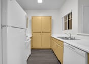 Thumbnail 25 of 48 - A kitchen with white appliances and wooden cabinets.